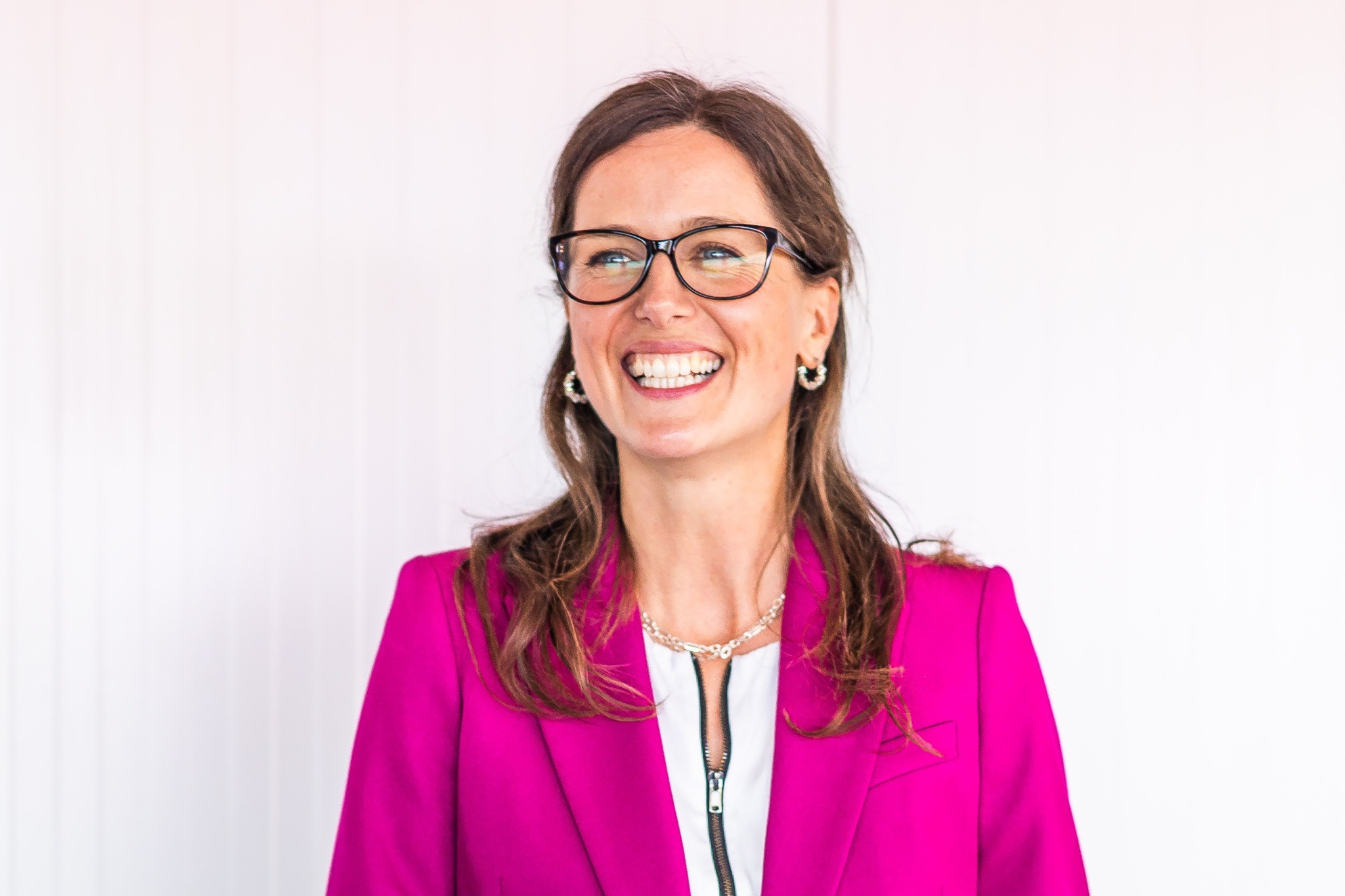 Sally smiling in a pink jacket